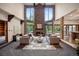Living room with a large stone fireplace, vaulted ceilings, and plenty of natural light at 12570 W 60Th Ave, Arvada, CO 80004