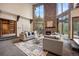 Spacious living room featuring stone fireplace, vaulted ceilings, and natural light at 12570 W 60Th Ave, Arvada, CO 80004