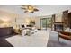 Bright main bedroom boasts a fireplace, hardwood floors, ceiling fan, and outdoor access at 12570 W 60Th Ave, Arvada, CO 80004