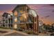 Two-story townhome with brick accents and private balcony at sunset at 1646 S Deframe St # A1, Lakewood, CO 80228