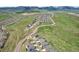 Expansive aerial view of a community surrounded by rolling hills and open spaces at 8803 Antero Ct, Arvada, CO 80007