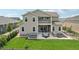 Two-story home featuring a backyard patio with a hot tub and outdoor seating area at 8803 Antero Ct, Arvada, CO 80007
