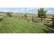 Enjoy your private backyard with gorgeous landscaping, a manicured lawn, and a rustic wood fence at 8803 Antero Ct, Arvada, CO 80007