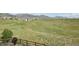 Large backyard with a greenbelt behind the fence, offering a private space and stunning views of the mountains at 8803 Antero Ct, Arvada, CO 80007