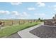 Manicured backyard with a lush lawn, stone patio, and scenic views beyond the fence at 8803 Antero Ct, Arvada, CO 80007