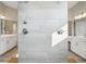 Stylish shower with tiled walls, modern fixtures, and dual vanity with ample counter space at 8803 Antero Ct, Arvada, CO 80007