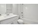 Bright bathroom featuring a sleek vanity and a tiled shower-over-tub at 8803 Antero Ct, Arvada, CO 80007