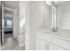 Bright bathroom featuring vanity with mirror and undermount sink; tile floors; and a view to the bedroom and shower at 8803 Antero Ct, Arvada, CO 80007