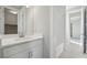 Bright bathroom featuring vanity with mirror and undermount sink; tile floors; and shower with glass doors and subway tile at 8803 Antero Ct, Arvada, CO 80007