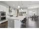 Modern kitchen featuring white cabinetry, stainless steel appliances, and an oversized island at 8803 Antero Ct, Arvada, CO 80007