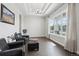 Bright living room with tray ceiling, large windows, and stylish seating arrangement at 8803 Antero Ct, Arvada, CO 80007