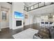 Bright and open living space with soaring ceilings, fireplace, modern decor, and second-story loft at 8803 Antero Ct, Arvada, CO 80007