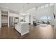 Spacious living room with dark wood floors, an island and a stunning backyard view at 8803 Antero Ct, Arvada, CO 80007