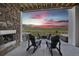 Outdoor living at its finest, with stone fireplace, built-in grill, hot tub, and chairs to enjoy the view at 8803 Antero Ct, Arvada, CO 80007