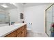 Bright bathroom featuring a shower with glass door, a single sink, and modern fixtures at 7558 S Ivanhoe Cir, Centennial, CO 80112