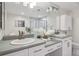 Luxurious bathroom featuring dual sinks, a large mirror, and contemporary finishes at 300 Hudson St # 109, Denver, CO 80220