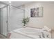 This relaxing bathroom features a soaking tub with shower and a large frosted glass shower at 300 Hudson St # 109, Denver, CO 80220