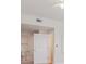 A bright, well-lit bedroom with a neutral palette and white door leading to the bathroom at 300 Hudson St # 109, Denver, CO 80220