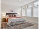 Bright bedroom featuring large windows, a comfortable queen-size bed, and stylish decor at 300 Hudson St # 109, Denver, CO 80220