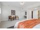 Well-lit bedroom featuring sitting chairs and a mirrored closet, creating a peaceful retreat at 300 Hudson St # 109, Denver, CO 80220