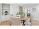 Elegant dining room with hardwood floors, decorative shelving, and comfortable upholstered chairs at 300 Hudson St # 109, Denver, CO 80220
