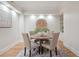 This stylish dining area features a round table with seating for four and built-in cabinets at 300 Hudson St # 109, Denver, CO 80220