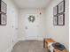 Bright entryway featuring tiled floors, a charming wreath, and decorative city-themed prints at 300 Hudson St # 109, Denver, CO 80220