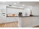 Stylish kitchen featuring bright cabinets, recessed lighting, and stone countertops at 300 Hudson St # 109, Denver, CO 80220