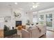 Cozy living room featuring a fireplace, comfortable seating, and abundant natural light at 300 Hudson St # 109, Denver, CO 80220
