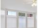 Bright wall of windows with cellular blinds and a ceiling fan overhead at 300 Hudson St # 109, Denver, CO 80220