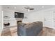 Finished basement featuring a modern fireplace, recessed lighting, and a dark grey sectional at 12119 Forest St, Thornton, CO 80241
