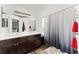 En suite bathroom features a dual sink vanity and shower tub with a tile surround at 12119 Forest St, Thornton, CO 80241