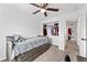 Bedroom features a ceiling fan and closet for clothing storage at 12119 Forest St, Thornton, CO 80241