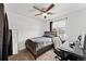 Bedroom with a ceiling fan, window, desk, and dark wood furniture at 12119 Forest St, Thornton, CO 80241