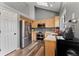 Modern kitchen featuring stainless steel appliances, granite countertops, and a skylight for natural light at 12119 Forest St, Thornton, CO 80241