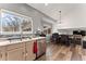 Modern kitchen with stainless steel appliances, stone countertops, wood cabinets and a large sunny window at 12119 Forest St, Thornton, CO 80241