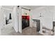Upper level landing area features in-unit laundry with stylish barn door and black appliances at 12119 Forest St, Thornton, CO 80241
