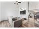 Bright living room features vaulted ceilings, skylights, hardwood floors, and large sectional couch at 12119 Forest St, Thornton, CO 80241