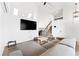 Bright living room features vaulted ceilings, skylights, hardwood floors, and large sectional couch at 12119 Forest St, Thornton, CO 80241