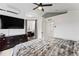 Large main bedroom featuring a ceiling fan, ensuite bath, and large wardrobe at 12119 Forest St, Thornton, CO 80241