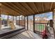 Covered porch with string lights, offers an outside play area overlooking the fenced backyard at 12119 Forest St, Thornton, CO 80241