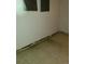Unfinished basement with white walls and tiled flooring, offering potential for customization at 451 Lansing St, Aurora, CO 80010