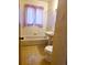 Bathroom with retro tilework, featuring a tub and pedestal sink at 451 Lansing St, Aurora, CO 80010
