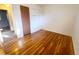 Hardwood floors in a bedroom featuring a closet and view to another room at 451 Lansing St, Aurora, CO 80010
