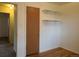Bedroom with hardwood floors and white walls, with closet door and shelving at 451 Lansing St, Aurora, CO 80010