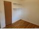 Bedroom featuring hardwood floors, neutral walls, and closet with shelving at 451 Lansing St, Aurora, CO 80010