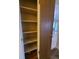 A linen closet featuring multiple shelves next to an open door showing the kitchen at 451 Lansing St, Aurora, CO 80010