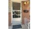 Close-up of the front door with security screen and brick exterior at 451 Lansing St, Aurora, CO 80010