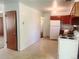 This is an empty kitchen featuring a white refrigerator, stove, and light brown cabinets with white walls at 451 Lansing St, Aurora, CO 80010