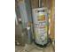This is a well-lit utility room featuring the home's furnace and hot water heater at 451 Lansing St, Aurora, CO 80010